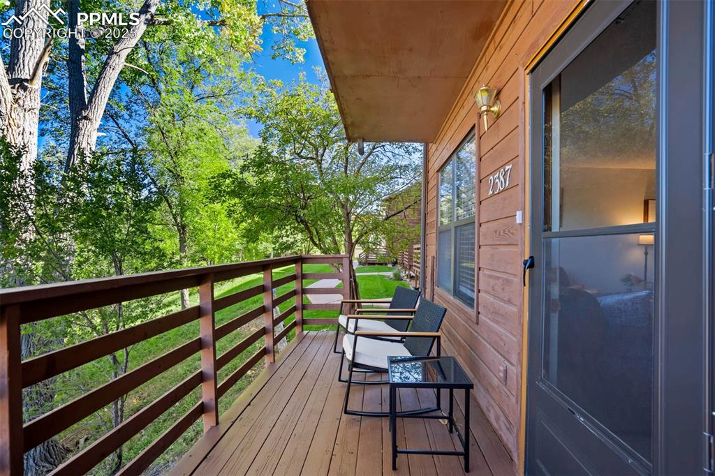 2387 Stepping Stones Way Colorado Springs, CO 80904 - Photo 8 of 35 a view of balcony with wooden floor and fence