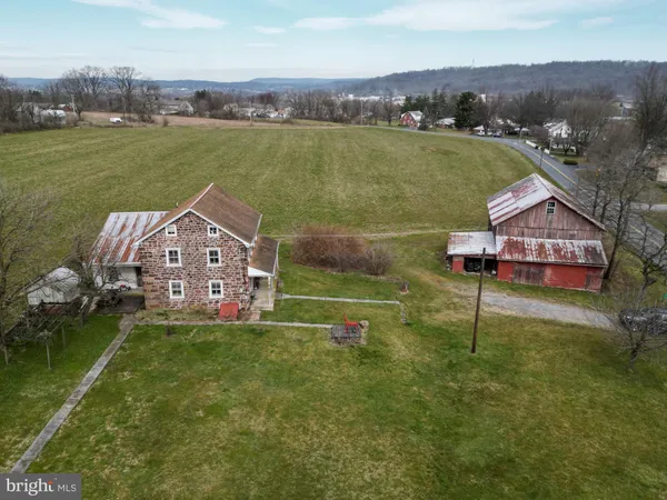 an aerial view of a house with a garden and lake view