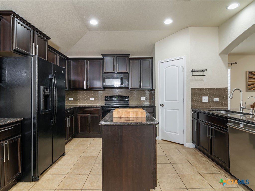 2231 Westover Loop New Braunfels, TX 78130 - Photo 14 of 35 a kitchen with stainless steel appliances granite countertop a refrigerator a stove and a sink