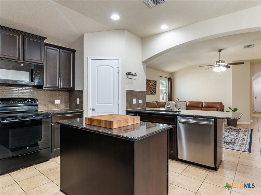 2231 Westover Loop New Braunfels, TX 78130 - Photo 15 of 36 a kitchen with stainless steel appliances granite countertop a sink stove and refrigerator