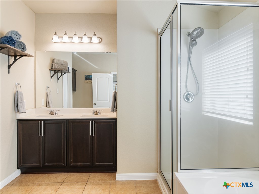 2231 Westover Loop New Braunfels, TX 78130 - Photo 24 of 36 a bathroom with a sink and a mirror