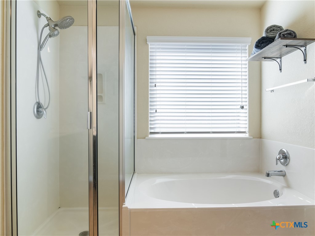2231 Westover Loop New Braunfels, TX 78130 - Photo 25 of 36 a bathroom with a bathtub and a shower