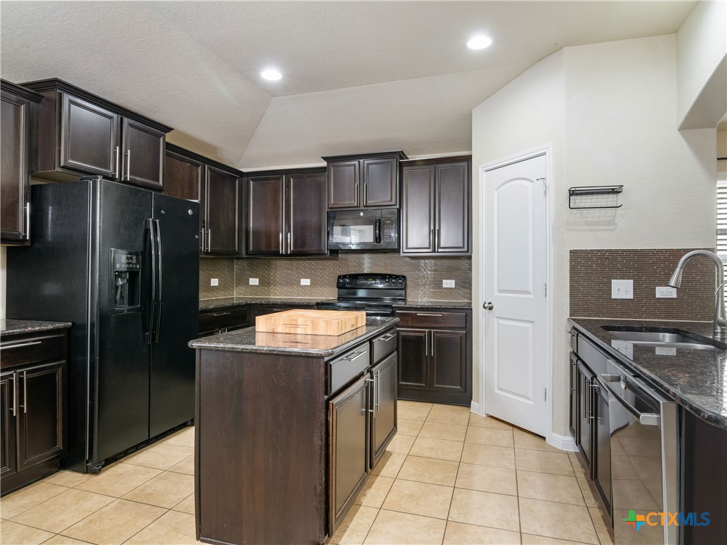 2231 Westover Loop New Braunfels, TX 78130 - Photo 5 of 35 a kitchen with stainless steel appliances granite countertop a stove a refrigerator and a sink