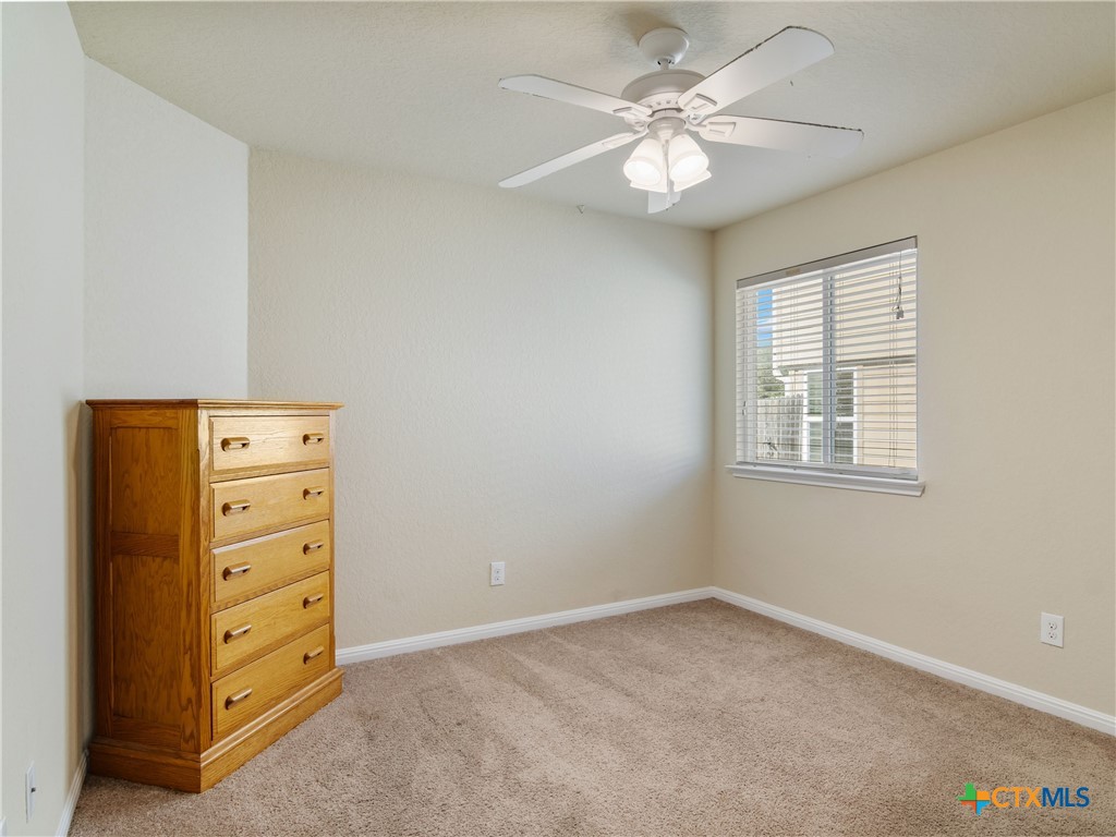 2231 Westover Loop New Braunfels, TX 78130 - Photo 7 of 36 an empty room with windows and fan