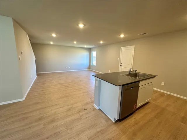 a white toilet sitting next to a white sink