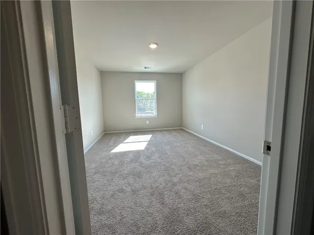 a kitchen with granite countertop a refrigerator stove top oven and sink