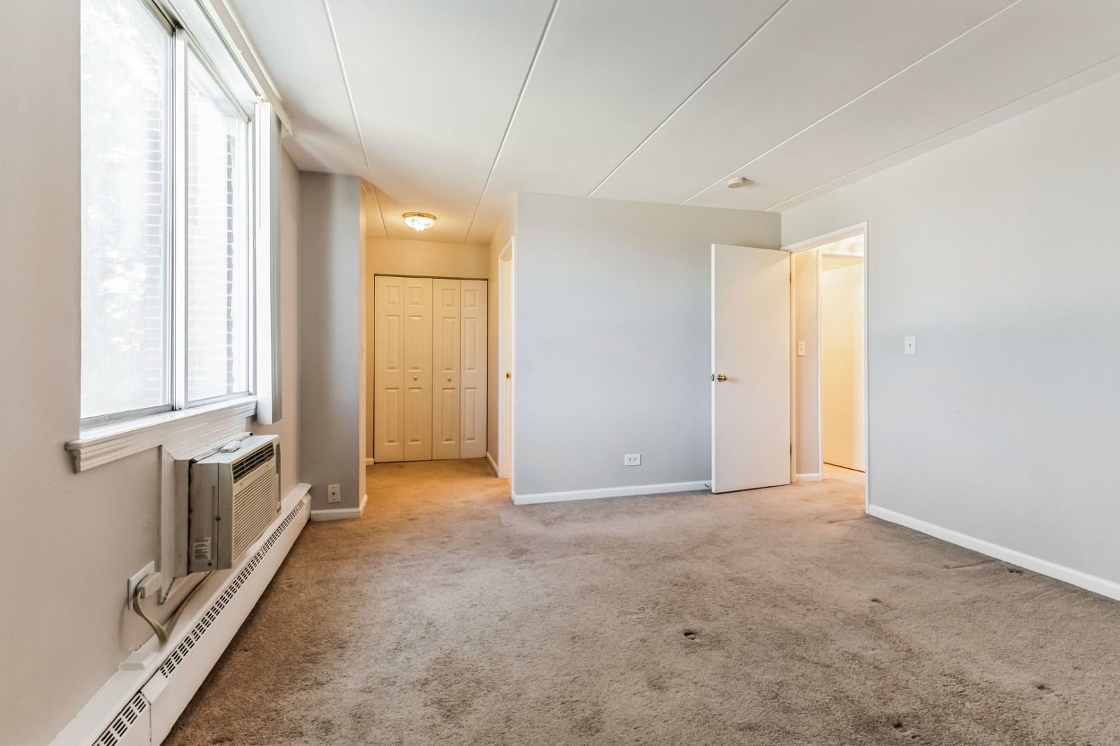 225 South Rohlwing Road, Unit 218 Palatine, IL 60074 - Photo 12 of 20 an empty room with windows and closet