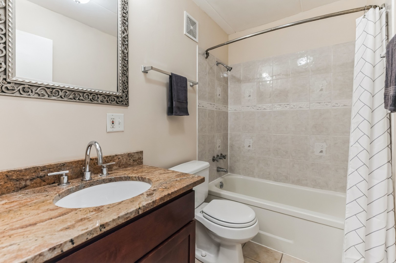 225 South Rohlwing Road, Unit 218 Palatine, IL 60074 - Photo 16 of 20 a bathroom with a granite countertop sink mirror toilet and bathtub