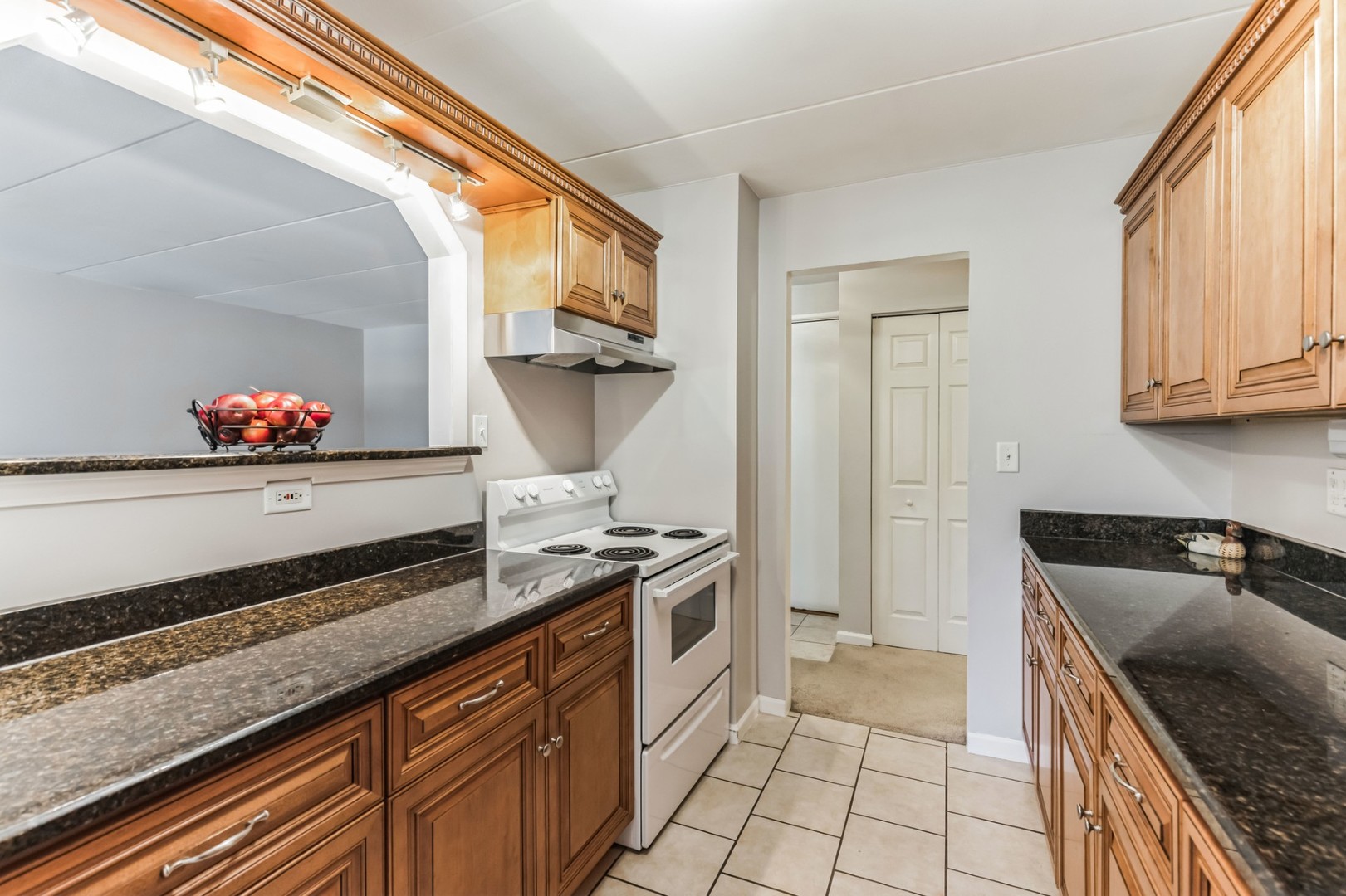 225 South Rohlwing Road, Unit 218 Palatine, IL 60074 - Photo 6 of 20 a kitchen with stainless steel appliances granite countertop a sink stove and cabinets