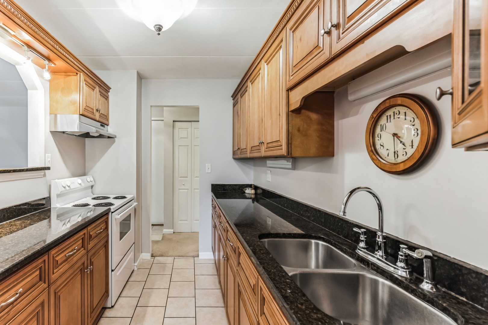 225 South Rohlwing Road, Unit 218 Palatine, IL 60074 - Photo 7 of 20 a kitchen with stainless steel appliances granite countertop a sink and a stove