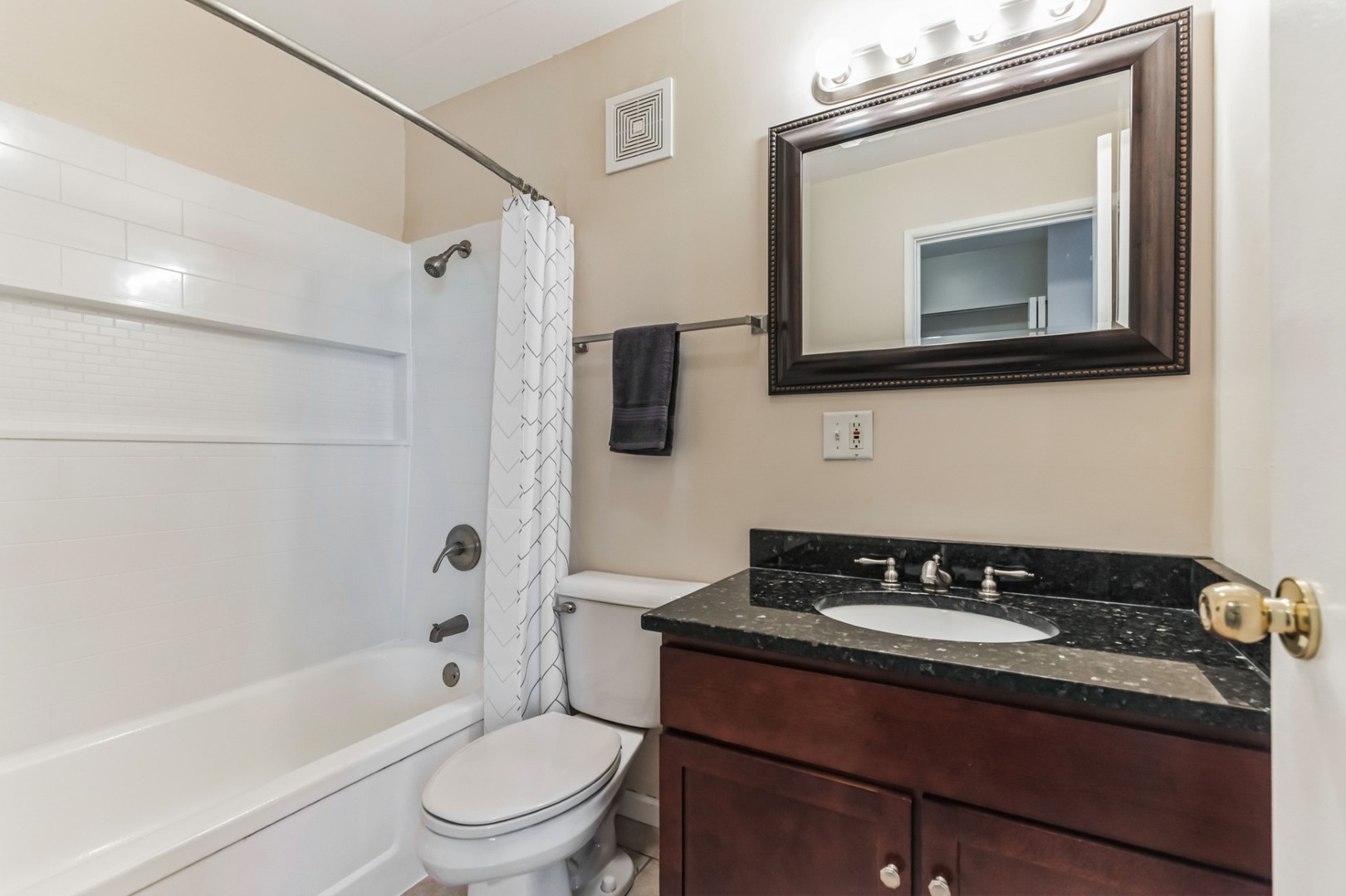 225 South Rohlwing Road, Unit 218 Palatine, IL 60074 - Photo 10 of 20 a bathroom with a granite countertop sink toilet a mirror and bathtub