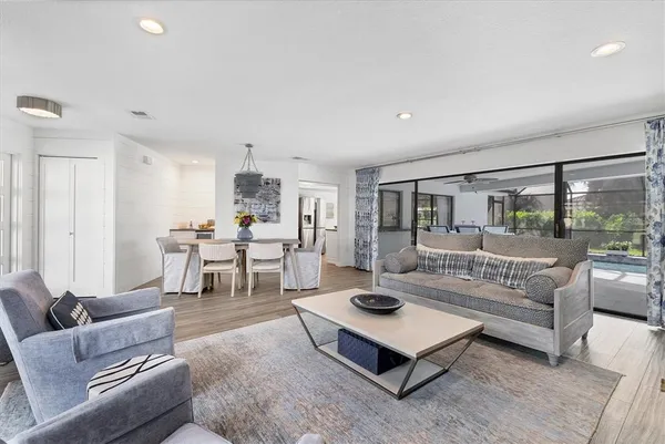 a living room with furniture a wooden floor and a fireplace
