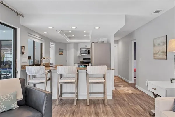 a kitchen with stainless steel appliances white cabinets and a granite counter tops