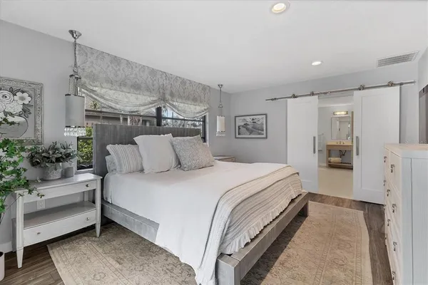 a bedroom with two beds and a large window