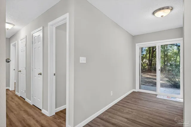 a view of wooden floor and windows in a room
