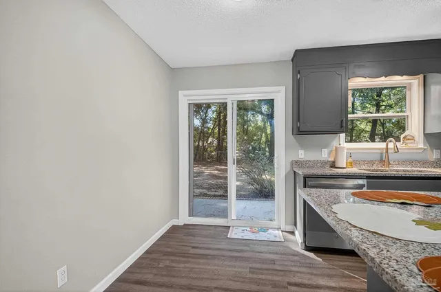 a view of a kitchen with a sink and a window