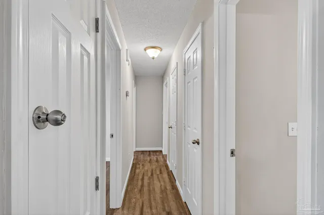a view of a hallway with wooden floor