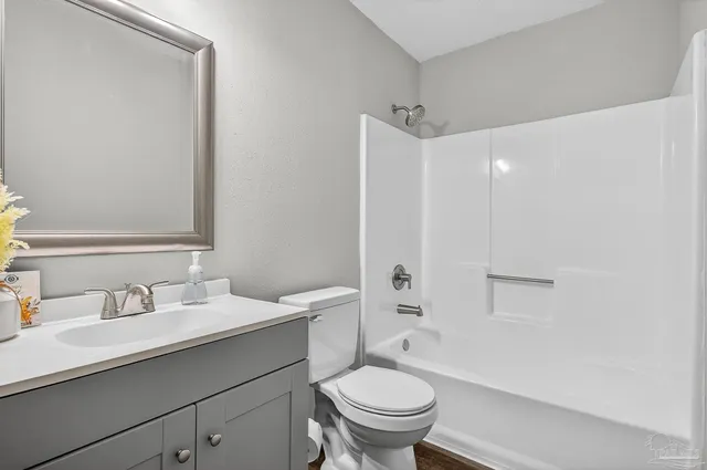 a bathroom with a sink toilet vanity and shower