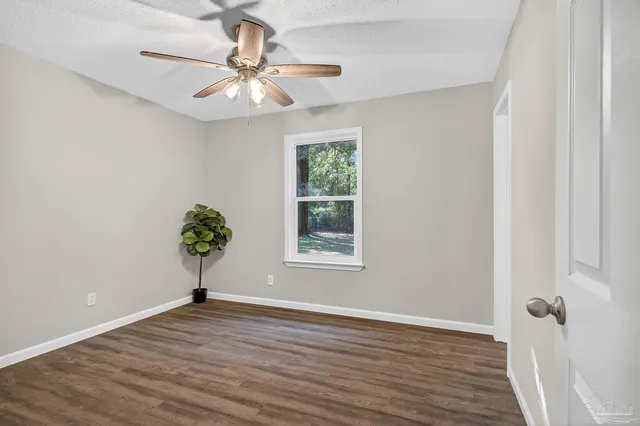 wooden floor in an empty room with a window