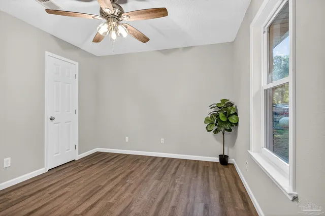 wooden floor in an empty room with a window