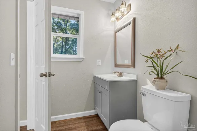 a bathroom with a toilet a sink and a mirror