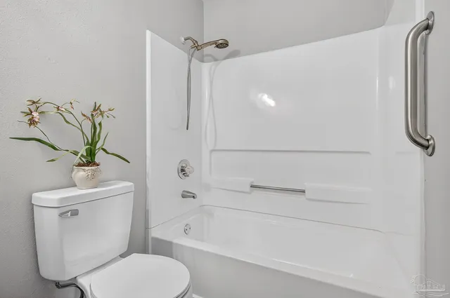 a bathroom with a toilet a sink and bathtub