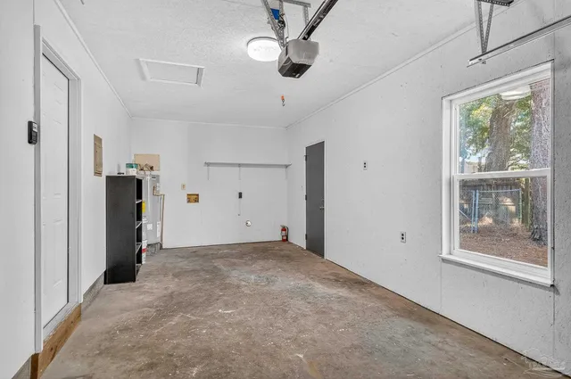 a view of empty room with window and ceiling fan