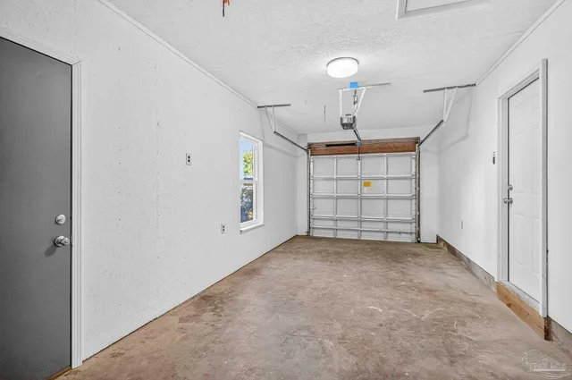 an empty room with windows and ceiling fan