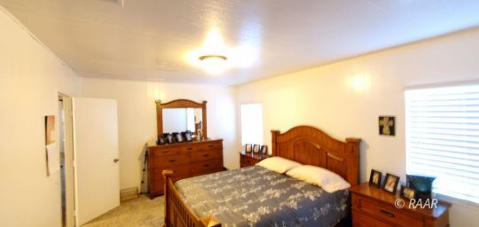 812 West Reeves Avenue Ridgecrest, CA 93555 - Photo 16 of 22 a bedroom with a bed and wooden floor