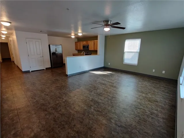 a view of a livingroom with a kitchen