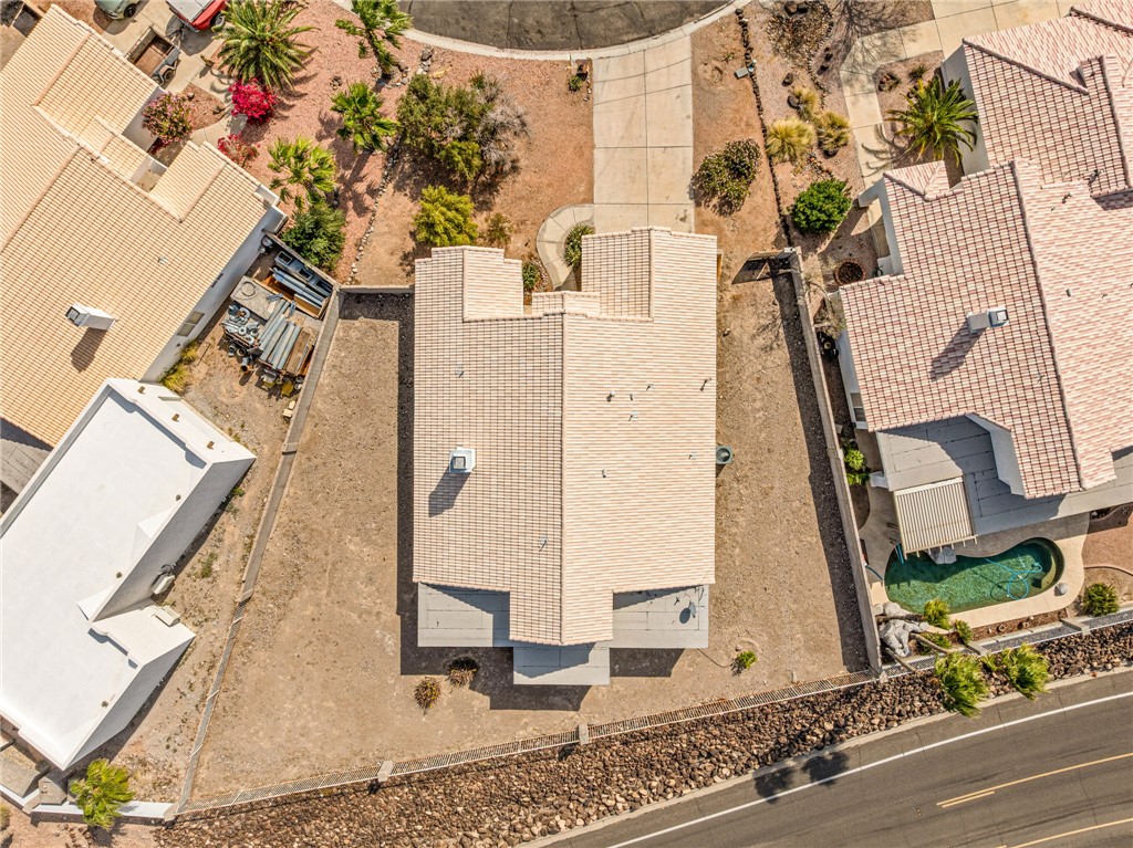 2853 Winchester Road Bullhead City, AZ 86442 - Photo 31 of 40 Aerial view of the property featuring a tiled roof, a paved driveway, and a spacious lot