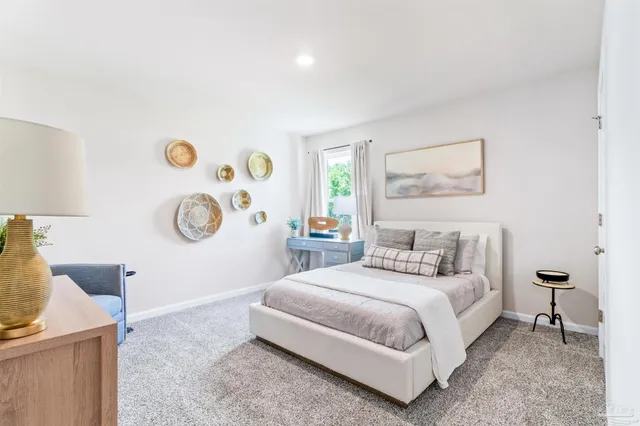 a bedroom with a bed and painting on the wall