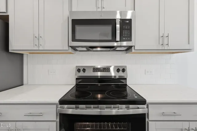 a stove top oven sitting inside of a kitchen