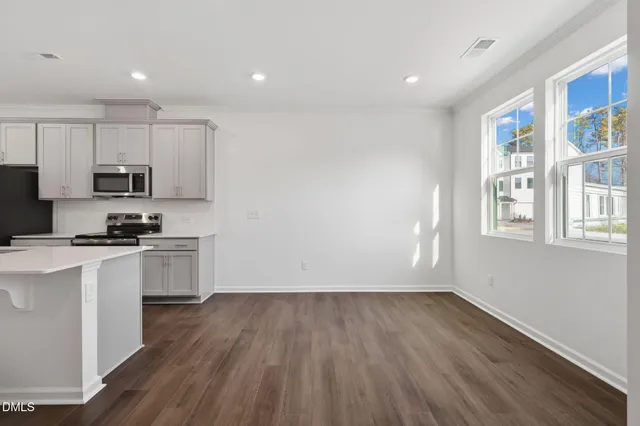 a kitchen with wooden floors and white appliances