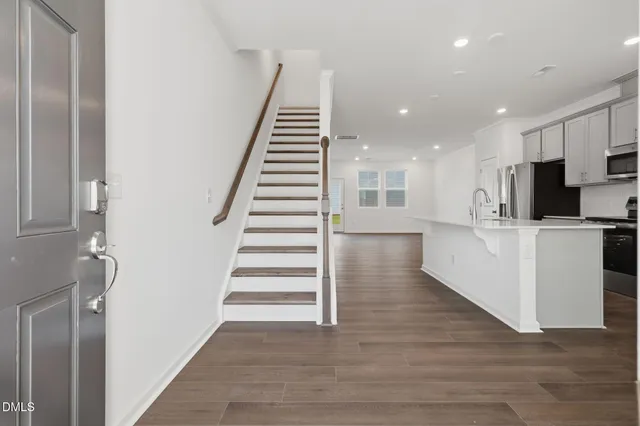 a view of a kitchen with wooden floor and electronic appliances
