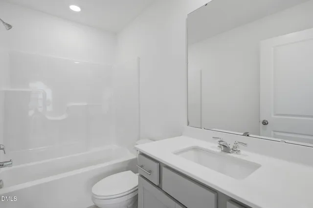 a bathroom with a sink a toilet and a bathtub