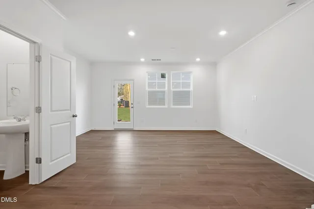 wooden floor in an empty room with a window