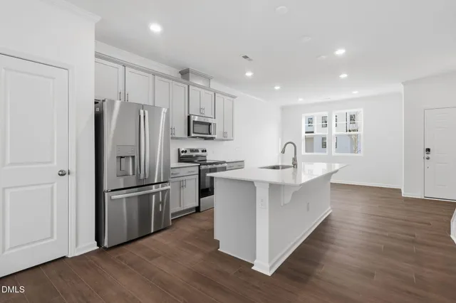 a kitchen with stainless steel appliances a refrigerator and a sink
