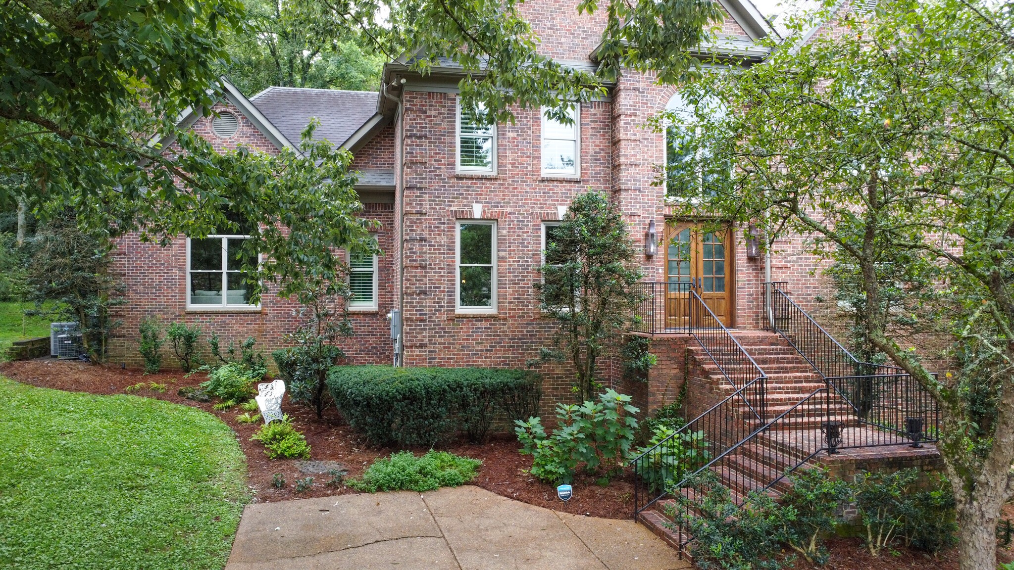a front view of a house with garden