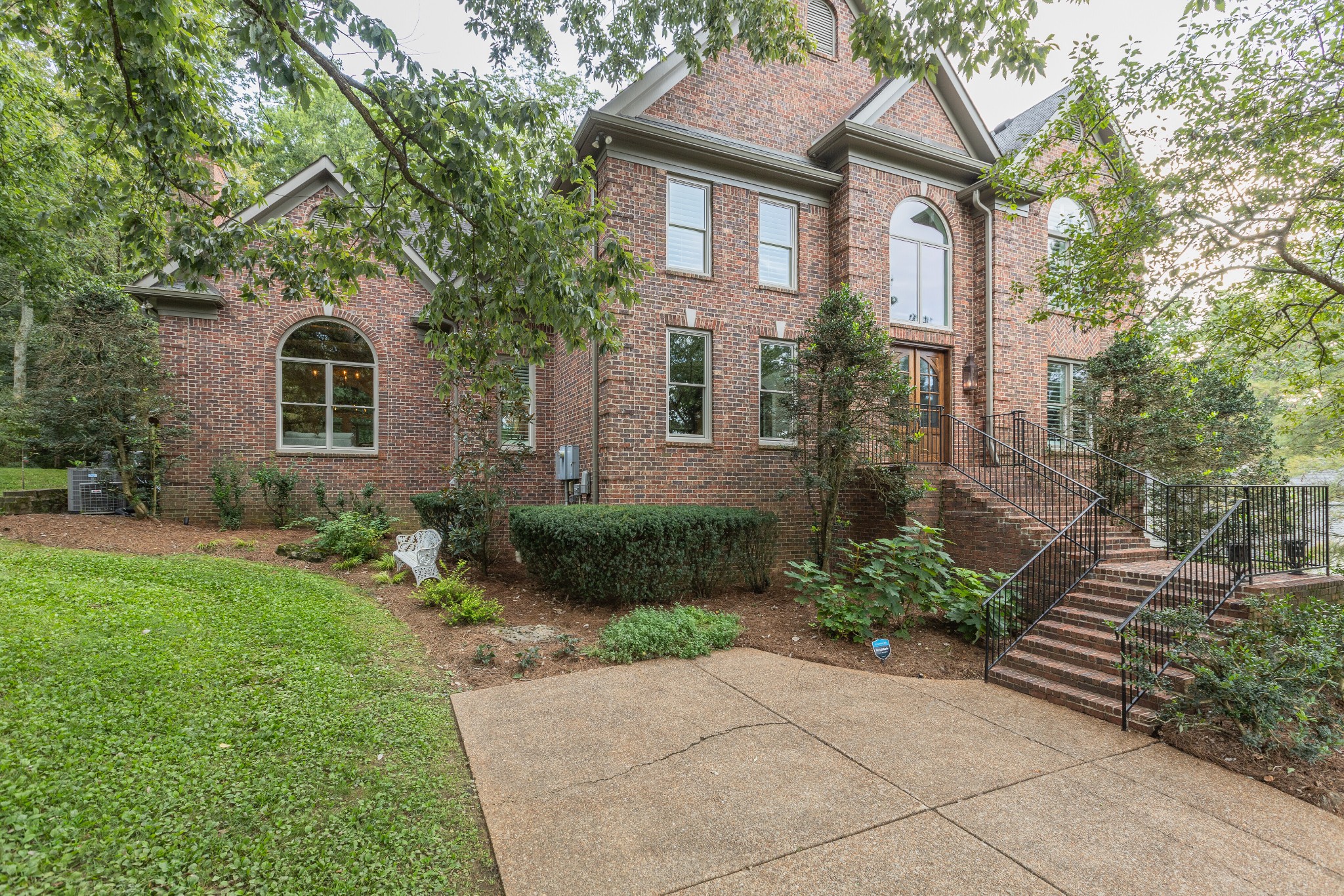 232 Bramerton Court Franklin, TN 37069 - Photo 2 of 58 a front view of a house with garden
