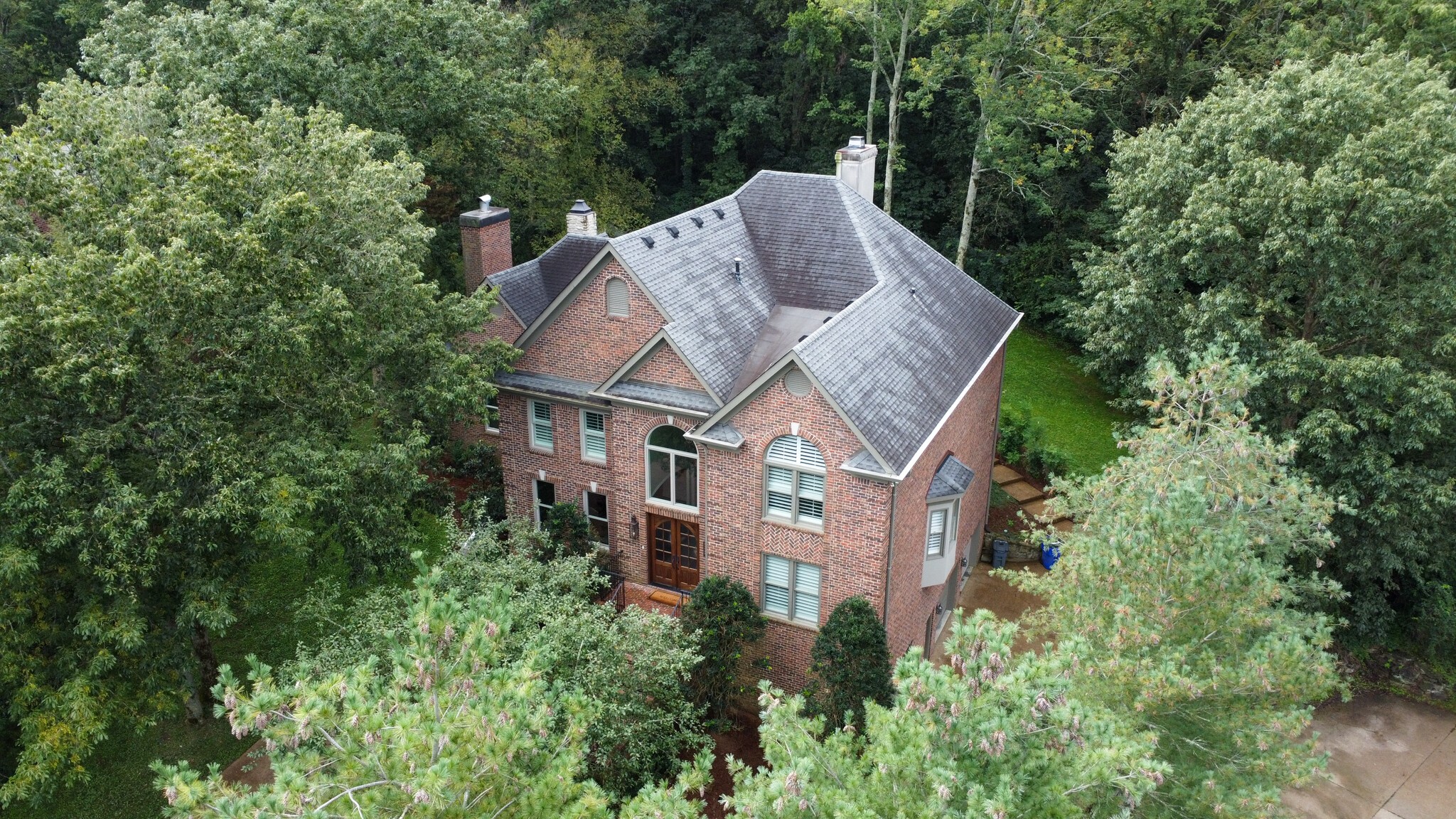 232 Bramerton Court Franklin, TN 37069 - Photo 5 of 58 an aerial view of a house with a yard and large trees