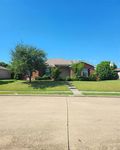 a view of a house with a big yard and palm trees