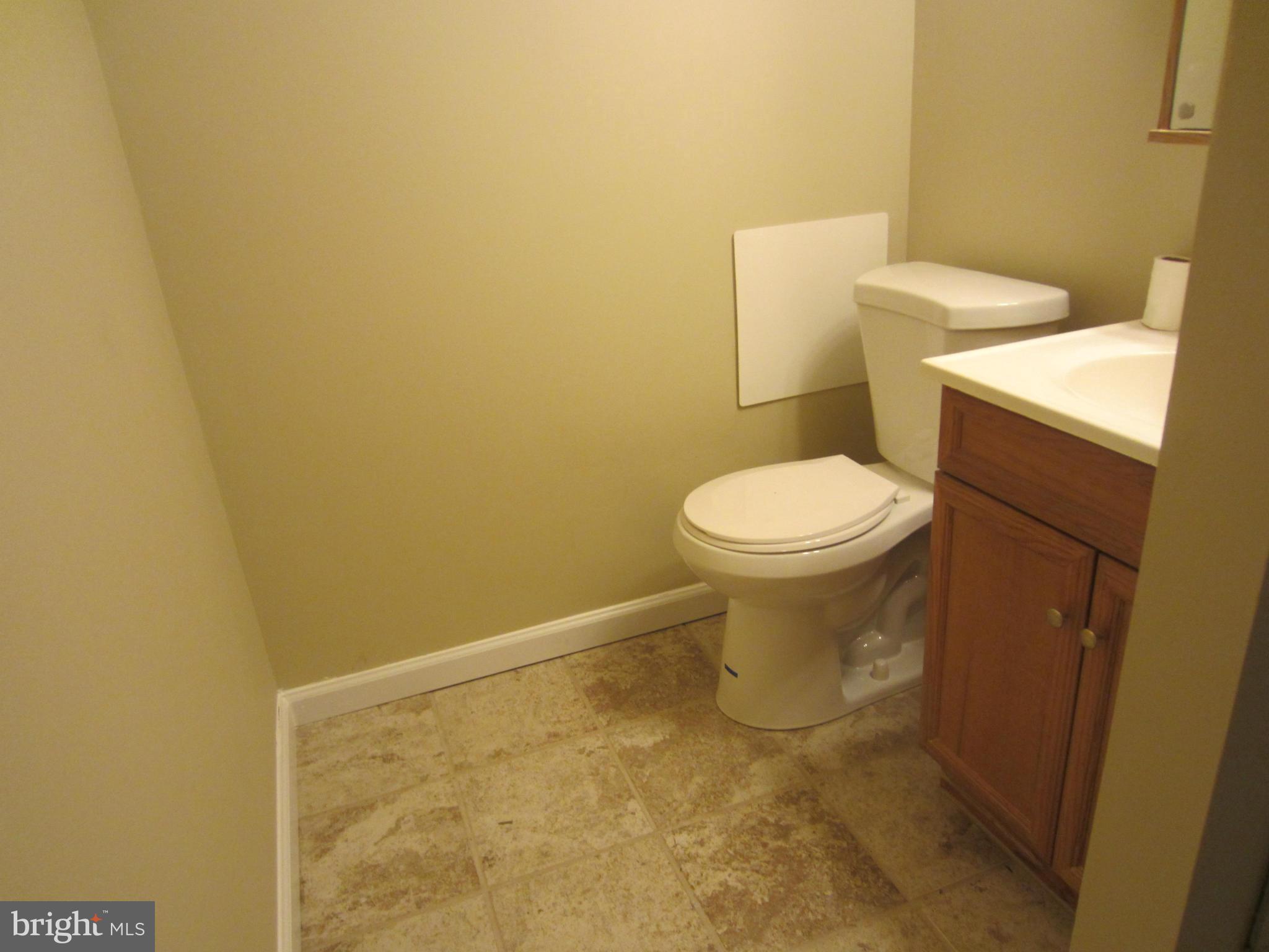 418 Laburnum Road Edgewood, MD 21040 - Photo 14 of 27 a white toilet sitting next to a white sink and vanity