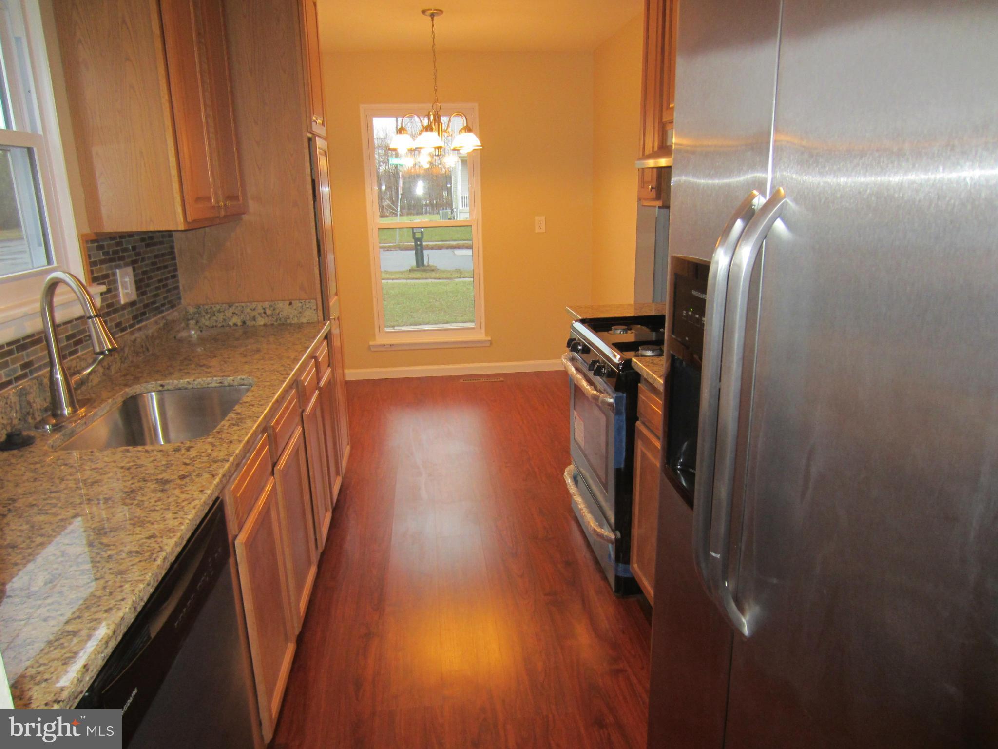 418 Laburnum Road Edgewood, MD 21040 - Photo 3 of 27 a kitchen with kitchen island granite countertop a sink stove and refrigerator