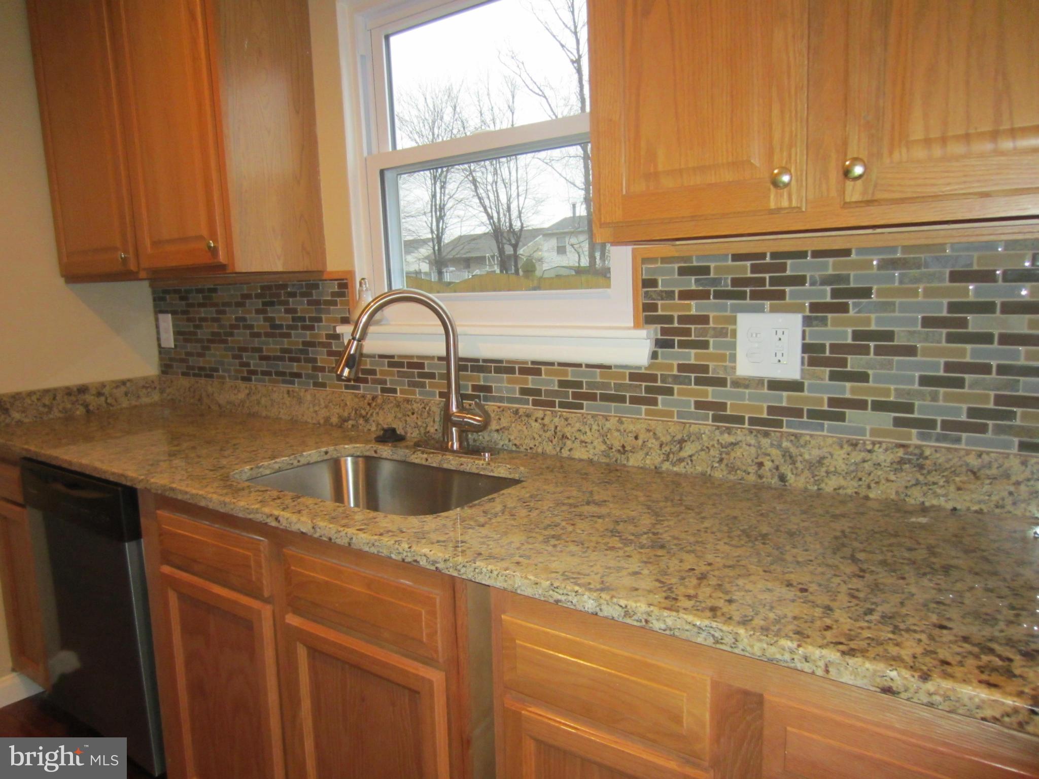 418 Laburnum Road Edgewood, MD 21040 - Photo 7 of 27 a kitchen with granite countertop a sink a window and cabinets