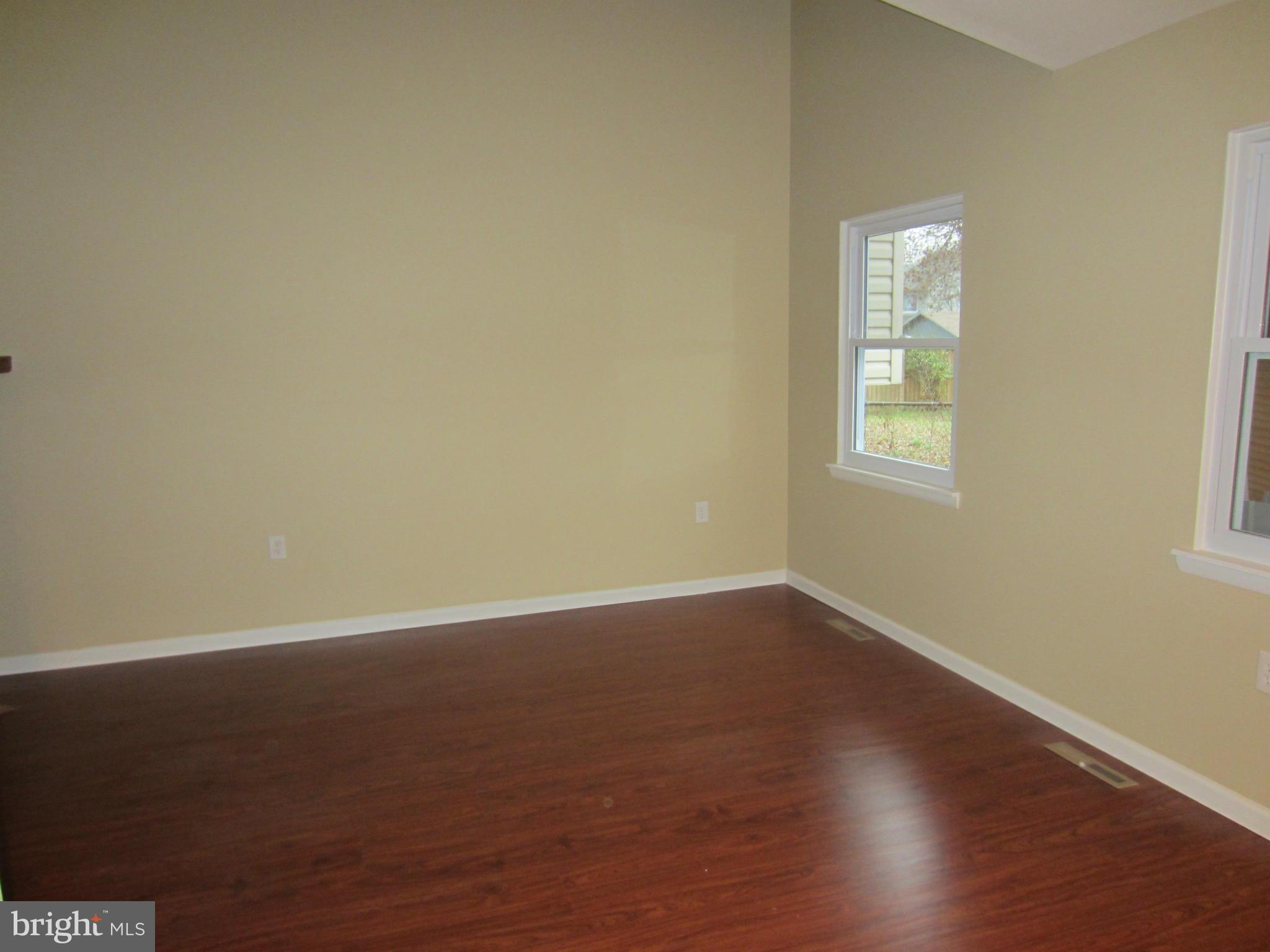 418 Laburnum Road Edgewood, MD 21040 - Photo 8 of 27 an empty room with wooden floor and windows