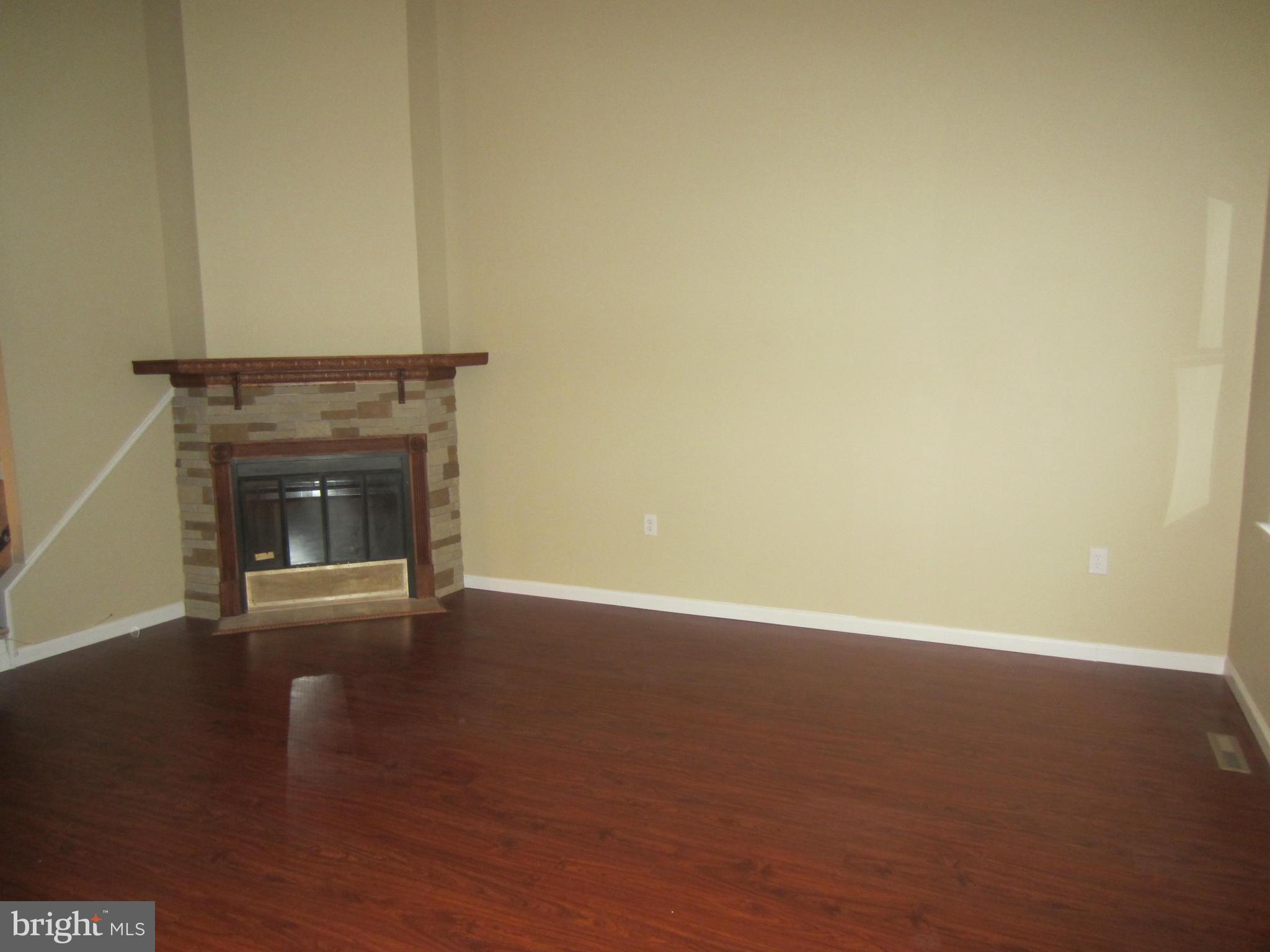 418 Laburnum Road Edgewood, MD 21040 - Photo 9 of 27 a view of an empty room with wooden floor and a fireplace