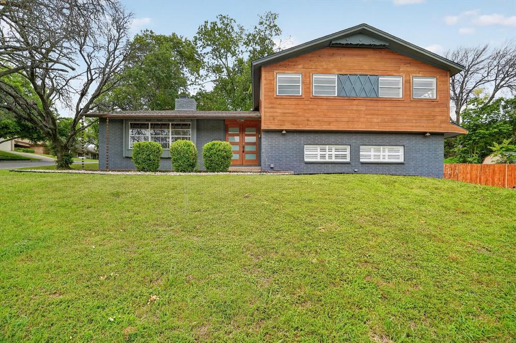 Contemporary two-story exterior featuring blue brick and wood siding