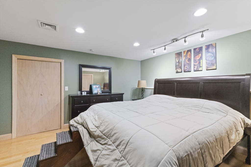 72 Ida Lane Fall River, MA 02720 - Photo 13 of 28 a bedroom with a large bed and a chandelier