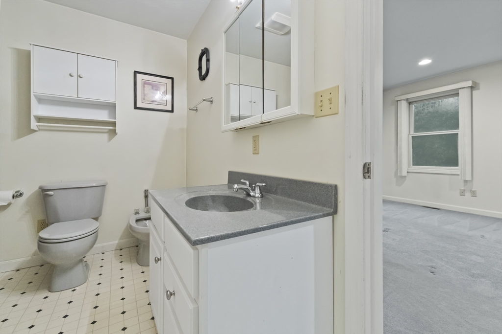 72 Ida Lane Fall River, MA 02720 - Photo 16 of 28 a bathroom with a granite countertop sink a toilet and a mirror